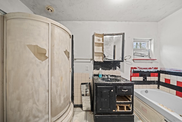 full bathroom featuring a stall shower, a garden tub, and vanity