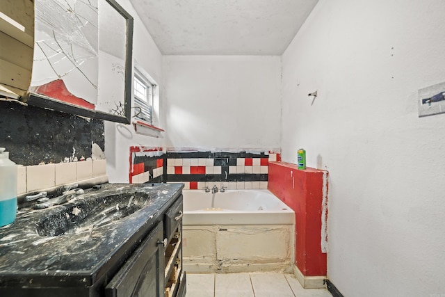 bathroom featuring tile patterned floors, vanity, and a bath