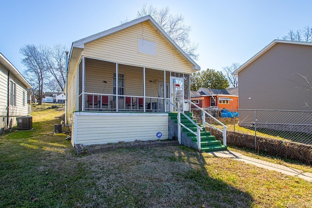 view of front of property with a porch, central AC, and a front yard