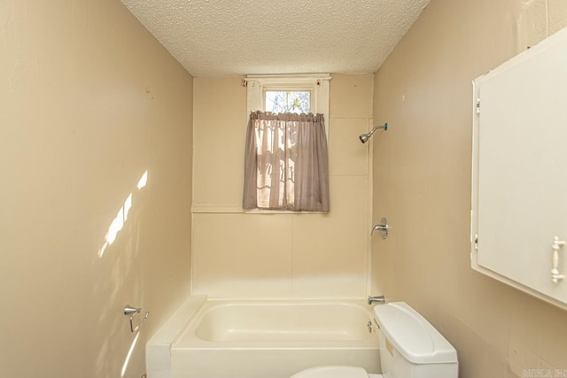 full bathroom featuring a textured ceiling, shower / bathing tub combination, and toilet