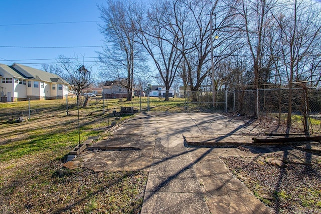 view of road featuring a residential view and concrete driveway