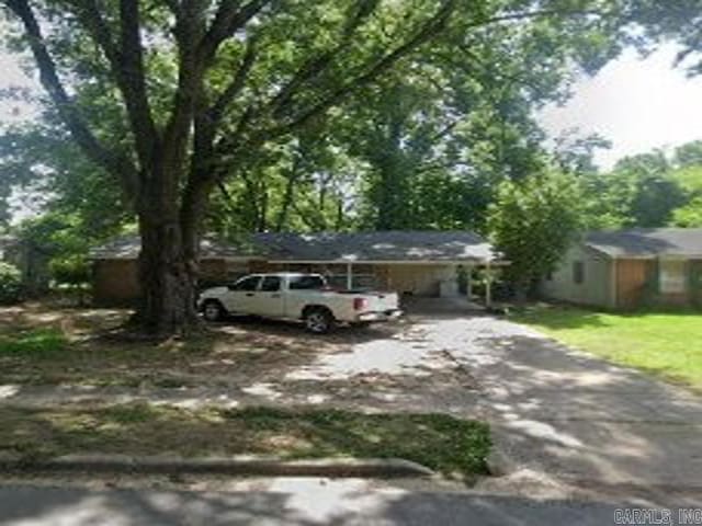 ranch-style home with driveway and a carport