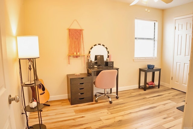 office area featuring a ceiling fan, baseboards, and wood finished floors