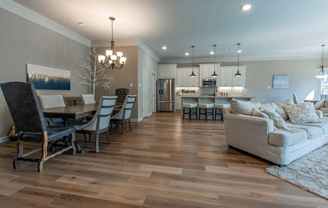 living room with baseboards, recessed lighting, wood finished floors, and a notable chandelier