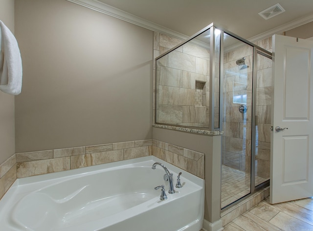 full bathroom featuring a stall shower, visible vents, crown molding, and a bath