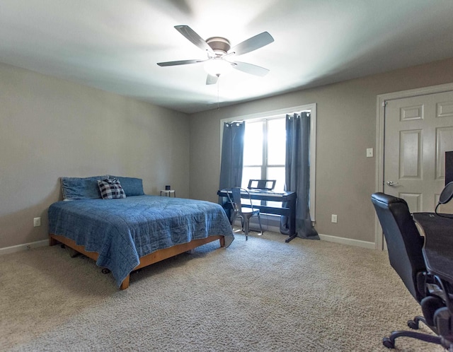 carpeted bedroom featuring ceiling fan and baseboards