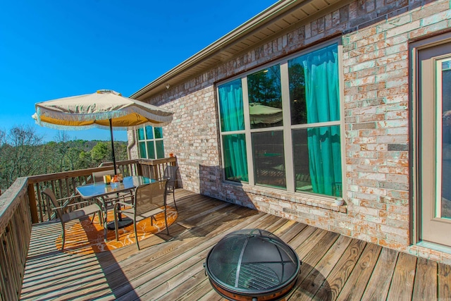 wooden terrace with outdoor dining area