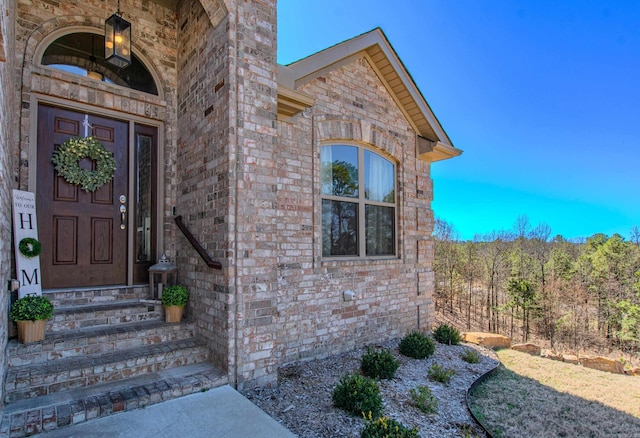 property entrance featuring brick siding
