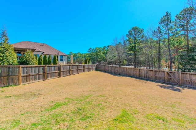 view of yard with a fenced backyard