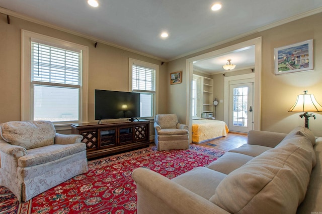 living area featuring ornamental molding, recessed lighting, and wood finished floors