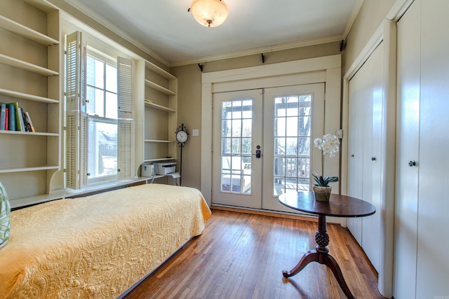 unfurnished bedroom featuring ornamental molding, access to outside, french doors, and wood finished floors