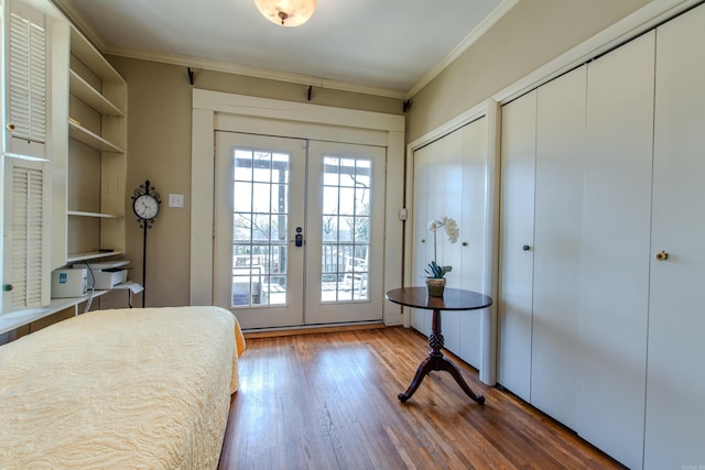 bedroom with multiple windows, crown molding, and french doors