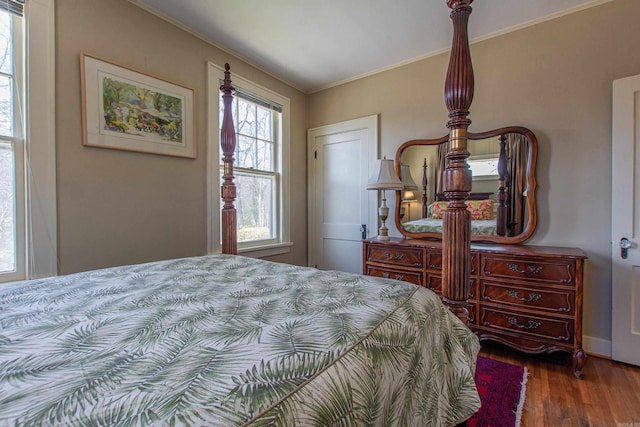 bedroom featuring crown molding and wood finished floors