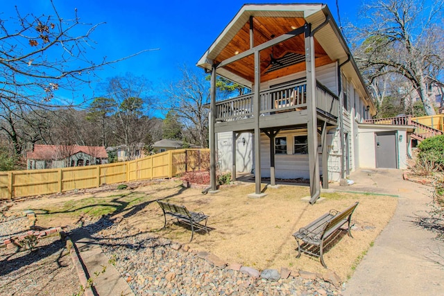 back of house featuring a deck and fence