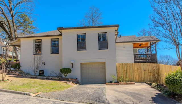 view of front of house with a garage, fence, and driveway