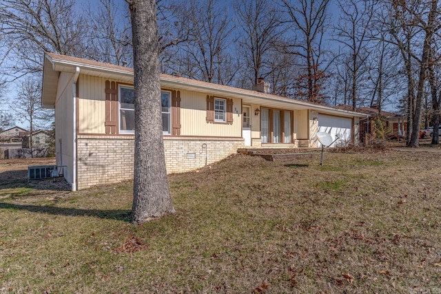 single story home featuring a garage, a front yard, brick siding, and a chimney