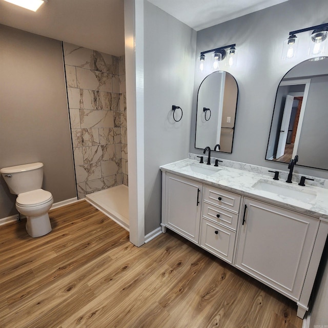 bathroom featuring wood finished floors, a sink, and toilet