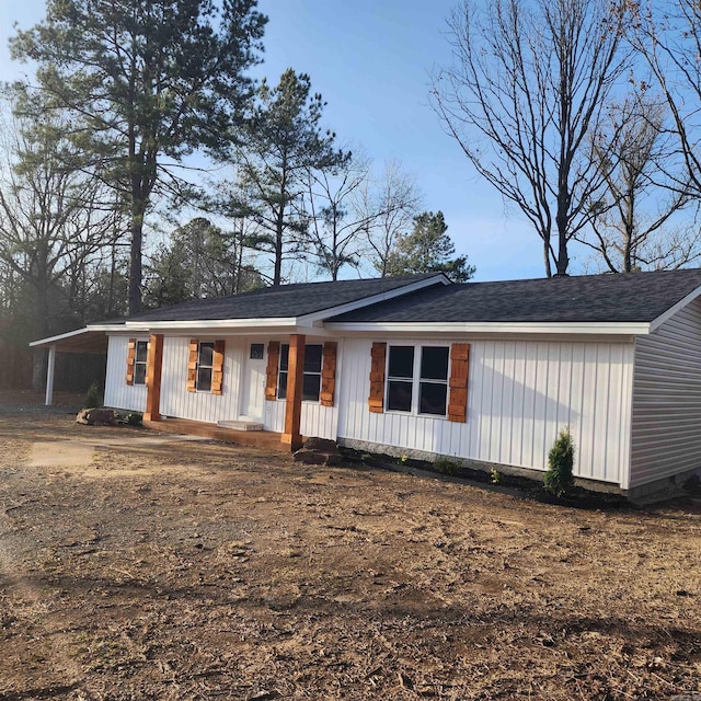 view of front of home with a porch and a carport