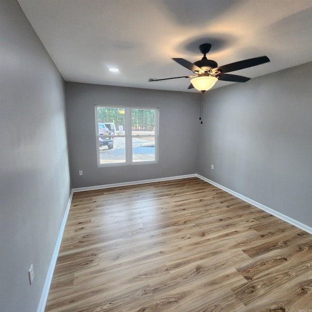 empty room with recessed lighting, ceiling fan, baseboards, and wood finished floors