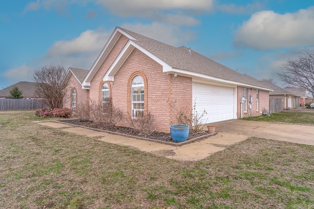 view of property exterior featuring driveway, an attached garage, a lawn, and brick siding