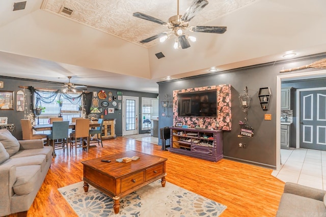 living room featuring high vaulted ceiling, a wealth of natural light, ceiling fan, and wood finished floors