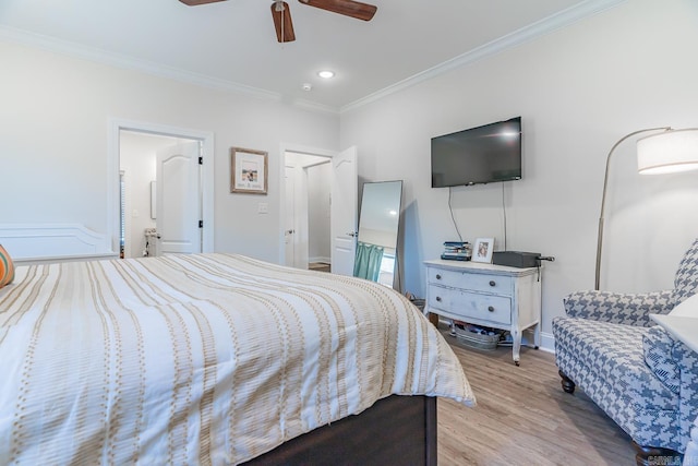 bedroom featuring ornamental molding, a ceiling fan, and light wood-style floors