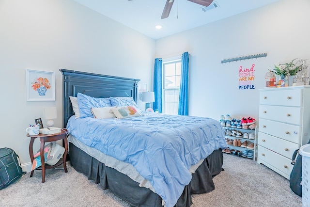 bedroom featuring ceiling fan, visible vents, and light colored carpet