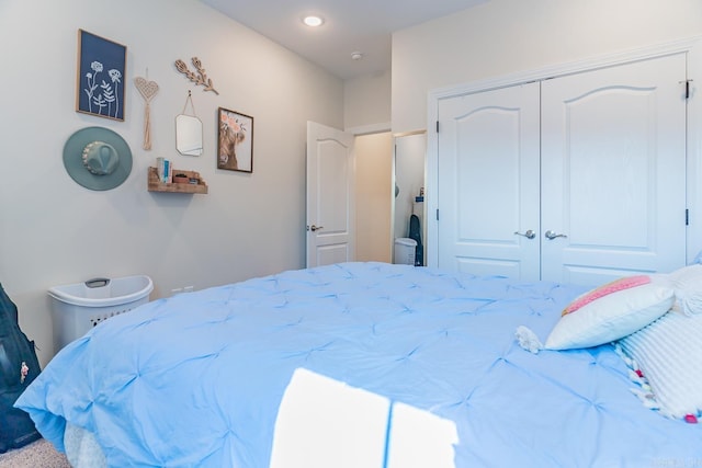 bedroom with recessed lighting and a closet