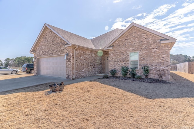 single story home with an attached garage, brick siding, fence, driveway, and roof with shingles