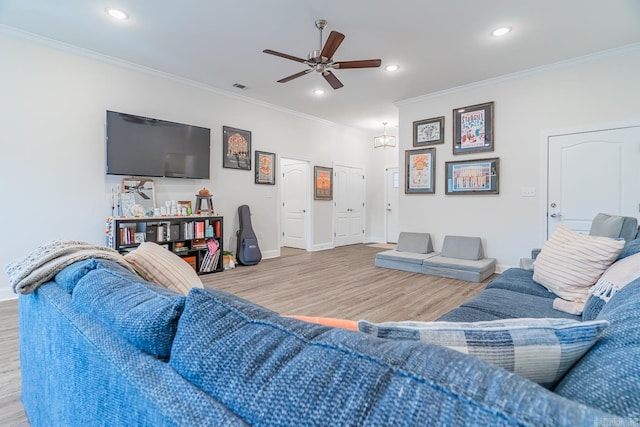 living room featuring ornamental molding, recessed lighting, and wood finished floors