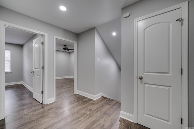 hall with baseboards, wood finished floors, and recessed lighting