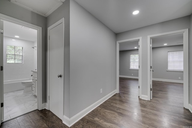 hall with baseboards, dark wood finished floors, and recessed lighting