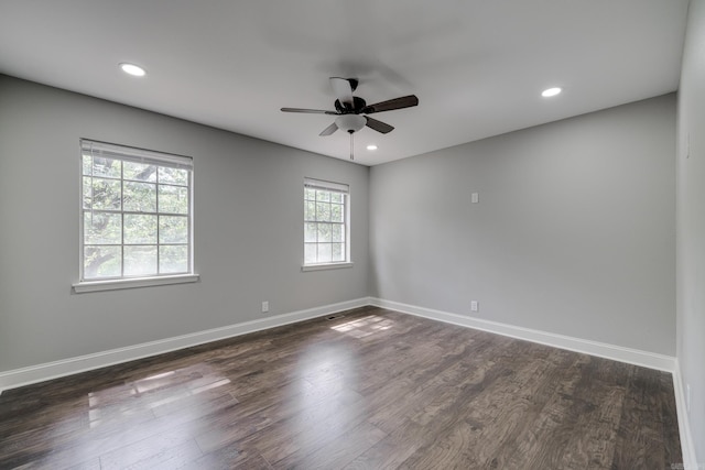 empty room featuring dark wood-type flooring, recessed lighting, baseboards, and a ceiling fan