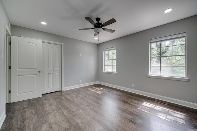 unfurnished bedroom featuring dark wood-style floors, baseboards, visible vents, and recessed lighting