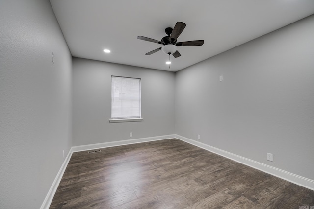 empty room with ceiling fan, recessed lighting, dark wood-type flooring, visible vents, and baseboards