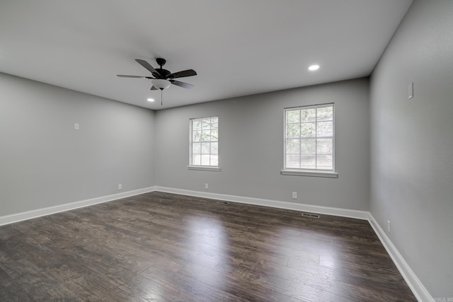 spare room with dark wood-style floors, baseboards, and recessed lighting