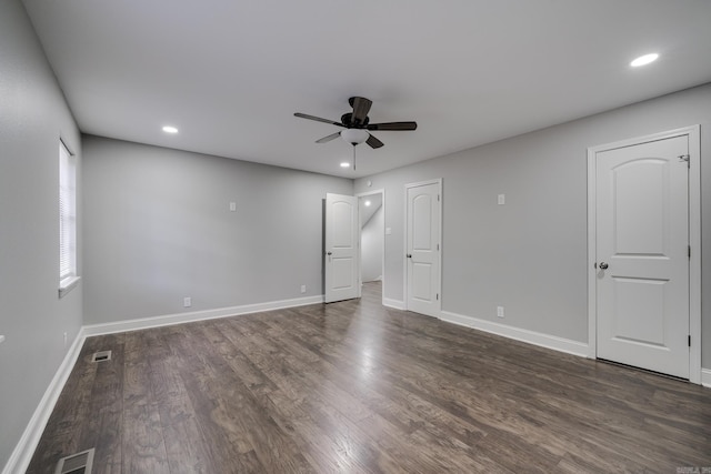 empty room with recessed lighting, dark wood-style flooring, visible vents, and baseboards