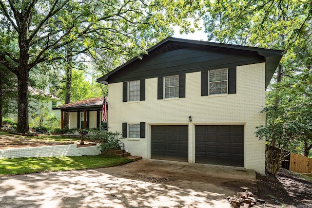 view of front of property featuring driveway, a garage, and brick siding