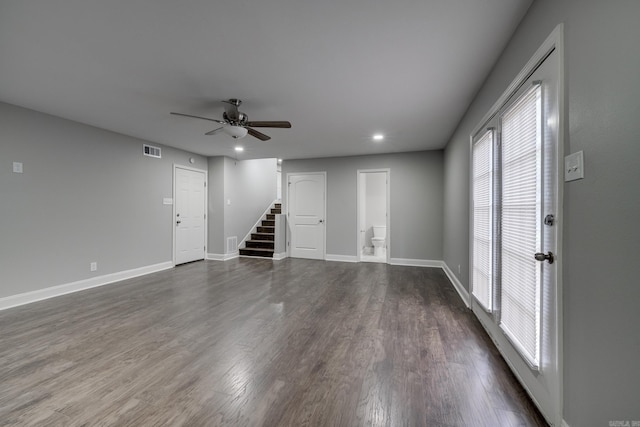 interior space with stairs, ceiling fan, dark wood-style flooring, and baseboards