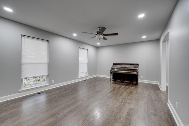 unfurnished living room featuring ceiling fan, baseboards, dark wood-type flooring, and recessed lighting