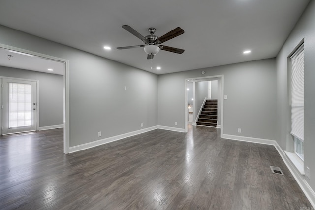 spare room with recessed lighting, visible vents, baseboards, stairway, and dark wood-style floors