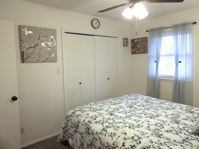 carpeted bedroom with a ceiling fan, a closet, and baseboards