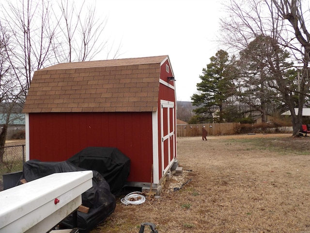 view of shed with fence