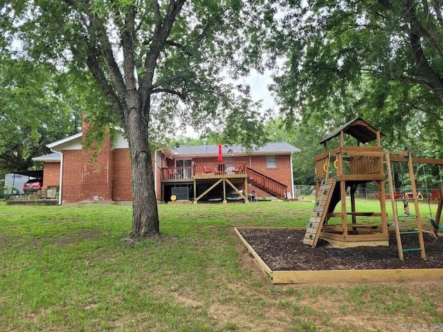 view of jungle gym featuring stairs, a yard, and a wooden deck