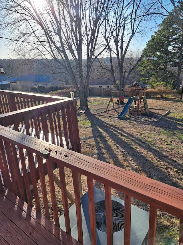 wooden deck featuring a playground