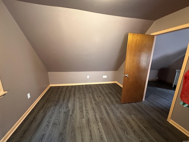 bonus room featuring baseboards, lofted ceiling, and dark wood-style flooring