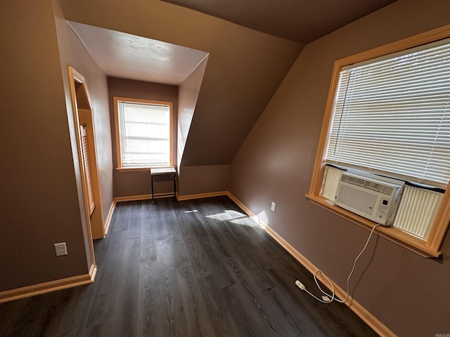 bonus room featuring dark wood-style floors, baseboards, and vaulted ceiling