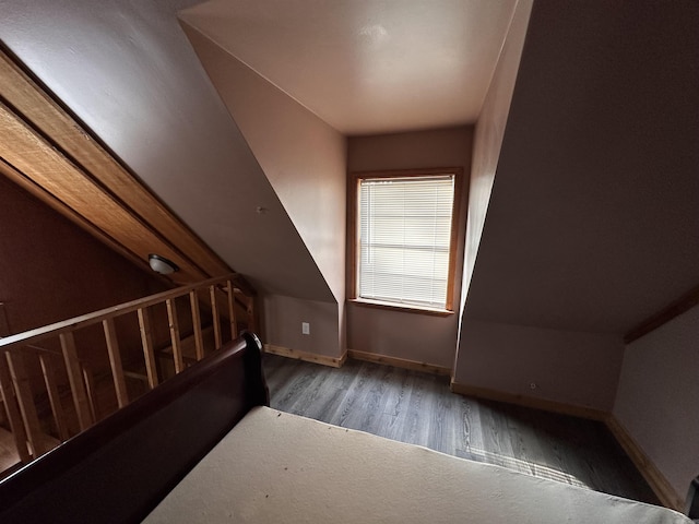 bonus room featuring baseboards and wood finished floors