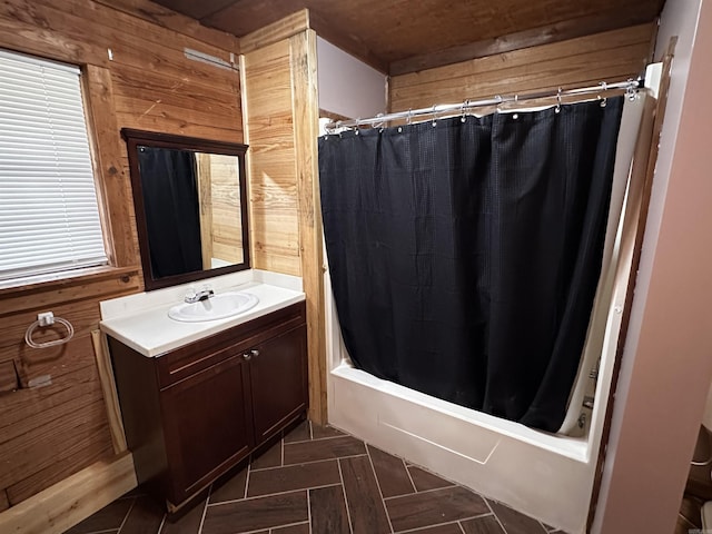 bathroom with vanity, wood walls, and shower / tub combo