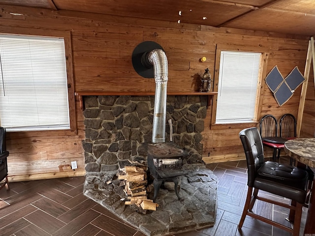 room details featuring wood walls and a wood stove